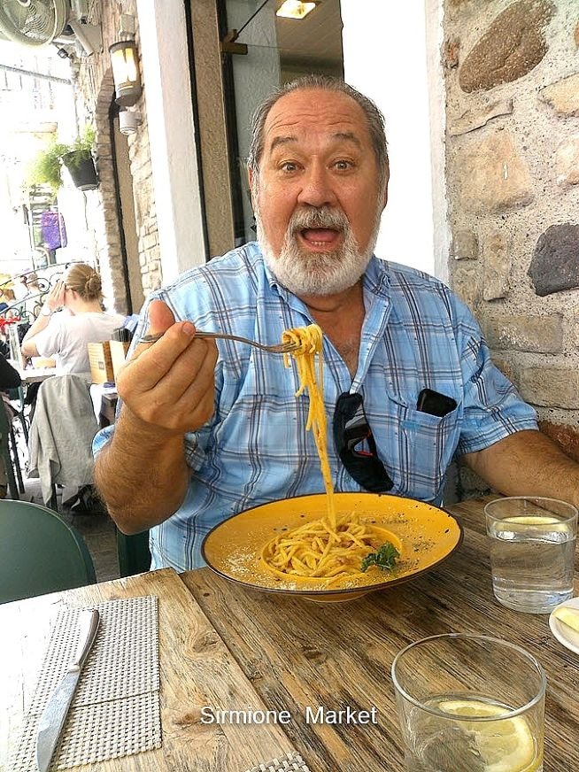 V. Les Rogers enjoying lunch at Lake Garda