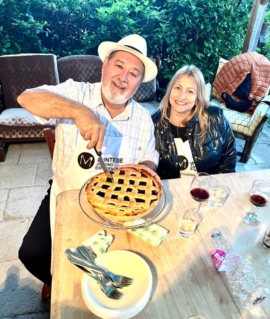 Couple displaying homemade pie cooking class San Gimignano
