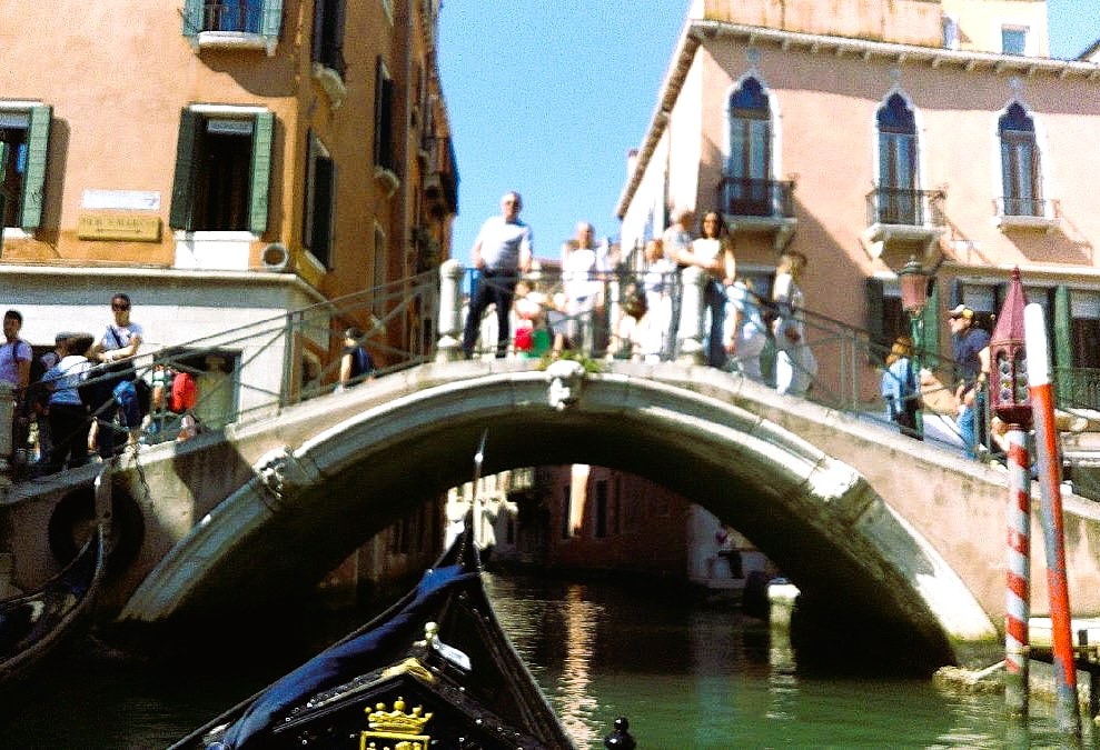 Gondola under arched bridge Venice Italy