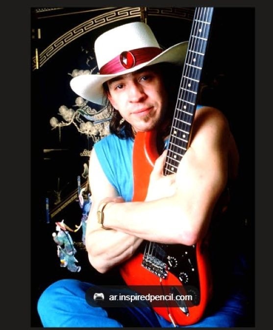 Stevie Ray Vaughan — arms crossed with guitar